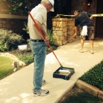Don and Bud paint the sidewalk in front of Tiffin House