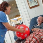 Ron and Tracy exercise with a ball at Tiffin House Assisted Living and Memory Care in Central Texas