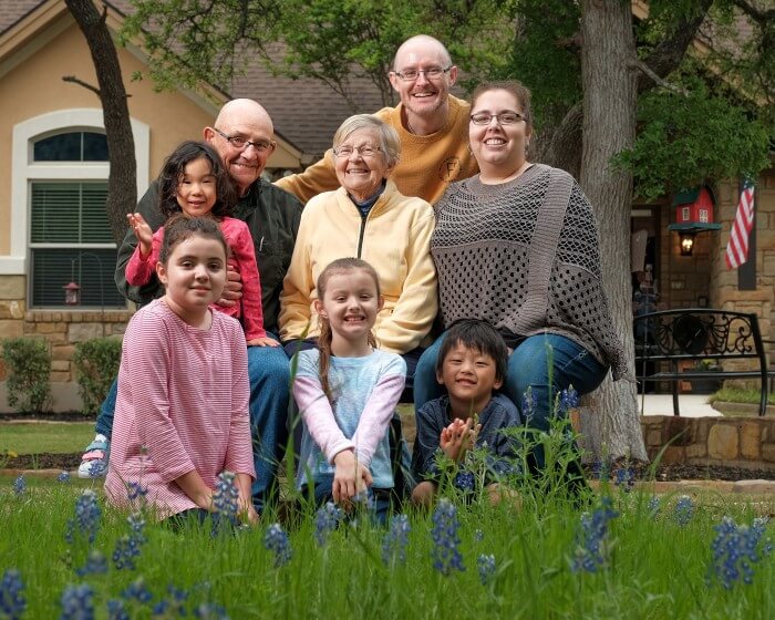 Tiffin House resident Higgie happily sits among the bluebonnets with her family